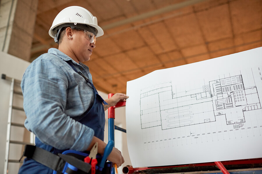 hvac-technician-checking-blueprints-ducts.jpg